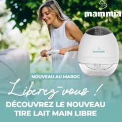 a woman holding a white brest pump mammia