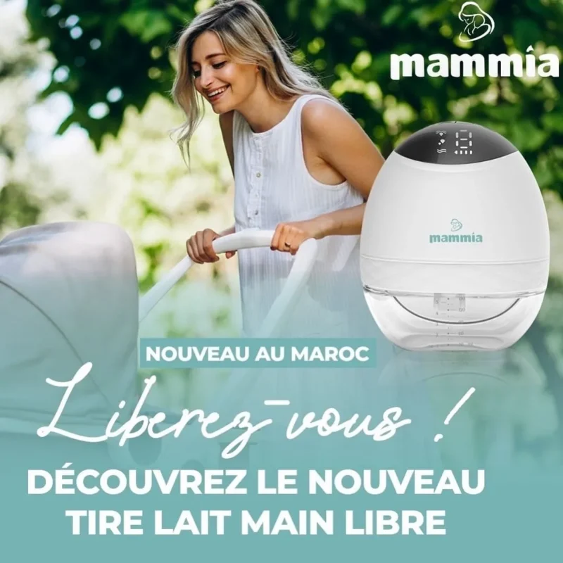 a woman holding a white brest pump mammia