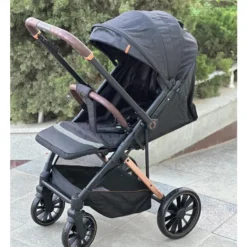a black baby stroller with brown handles kidilo