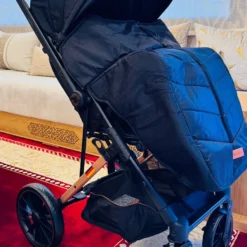 a black baby stroller with a black cover