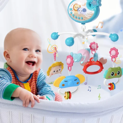 bébé dans son lit avec mobile musical vert